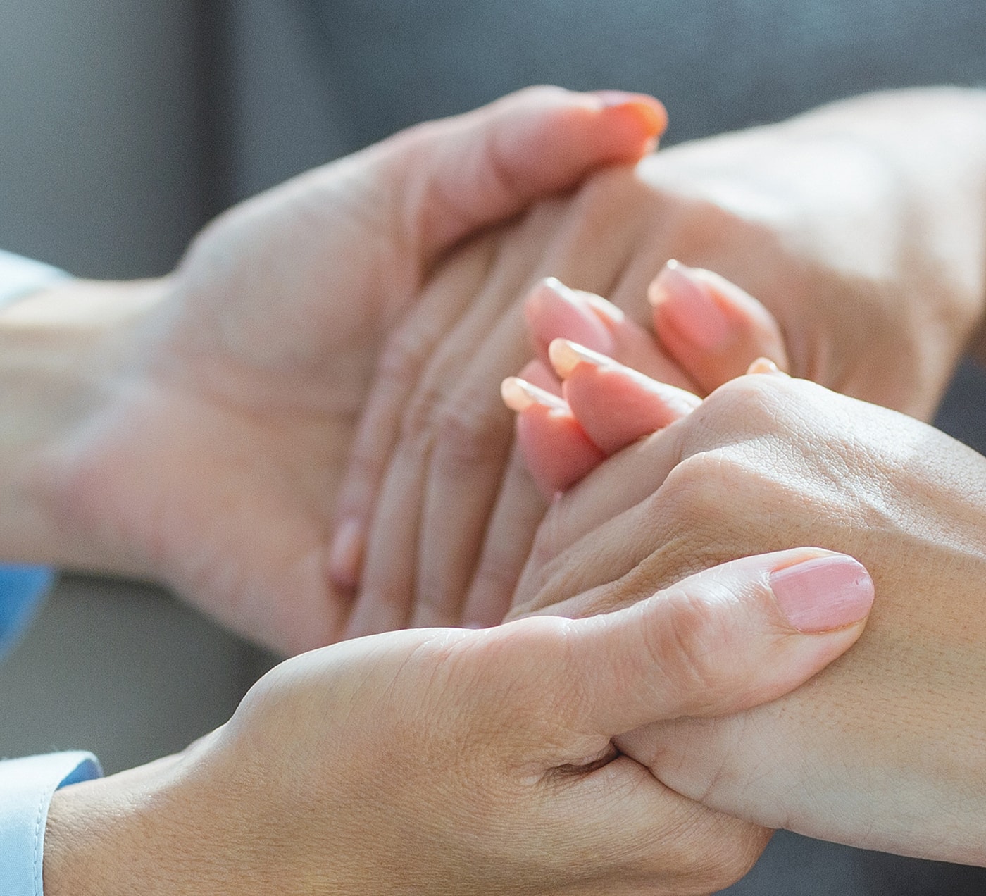 Two hands holding each other gently.