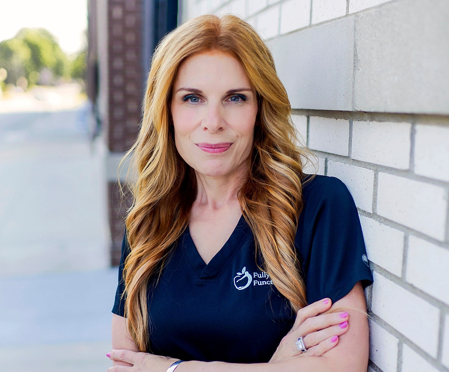 Woman with long hair in professional attire.