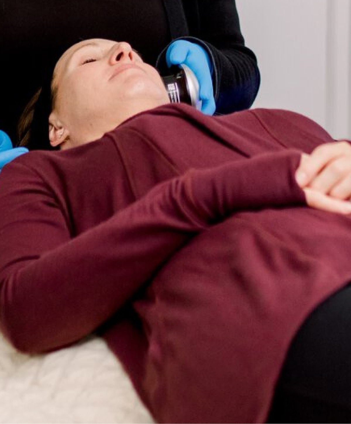 Woman receiving a facial treatment in clinic.