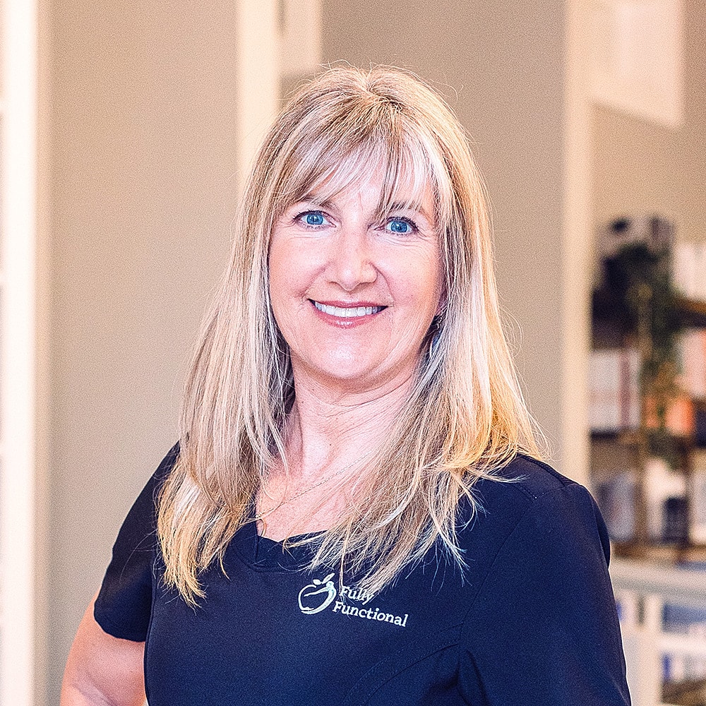 Smiling professional in health and wellness setting.