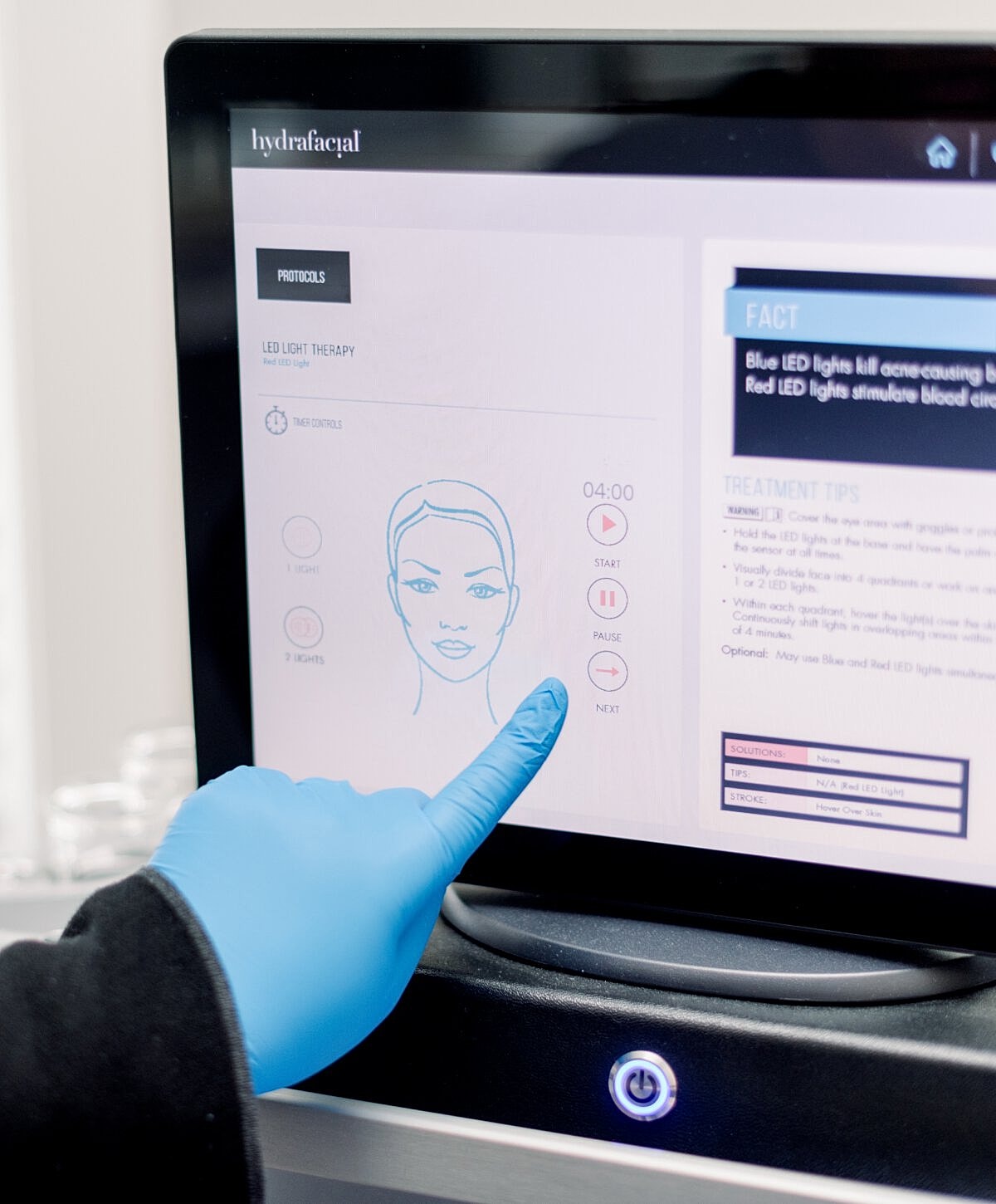 Using touchscreen for LED light therapy settings.
