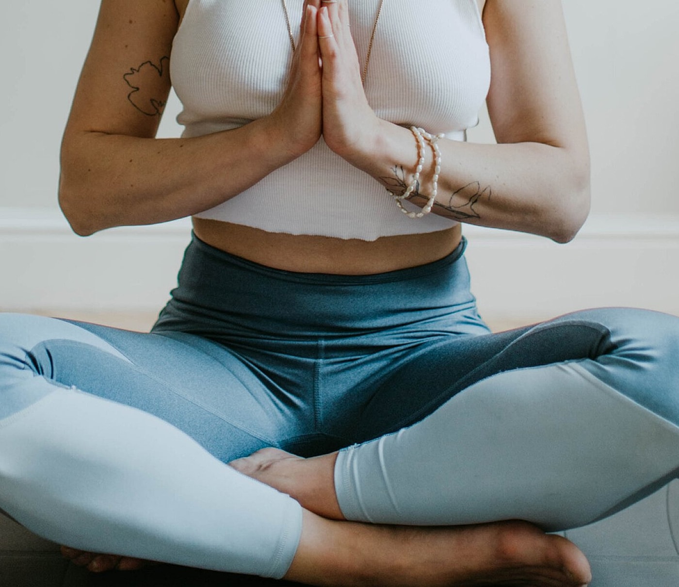 Person meditating in a peaceful setting.