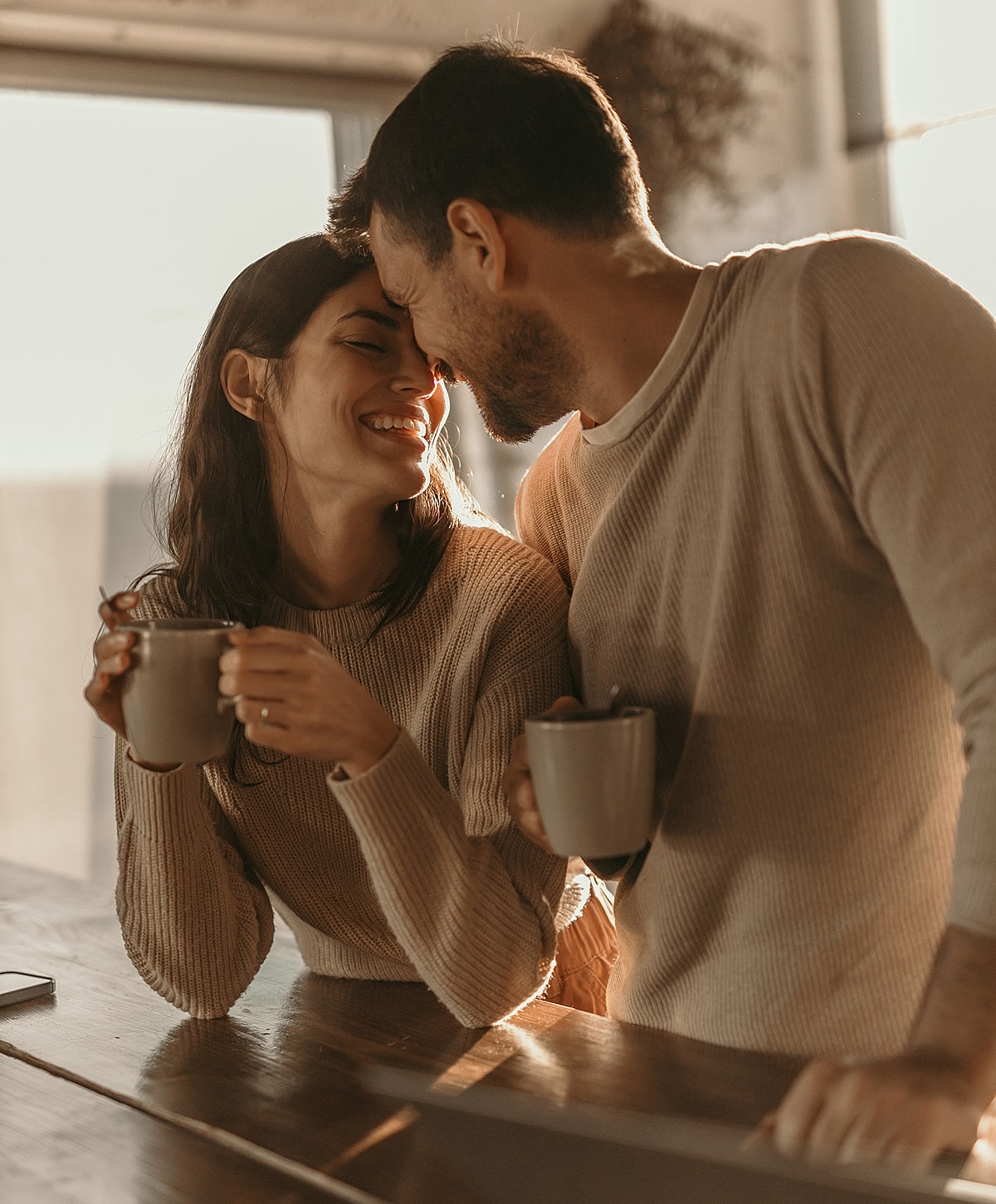 Couple enjoying coffee together at home.