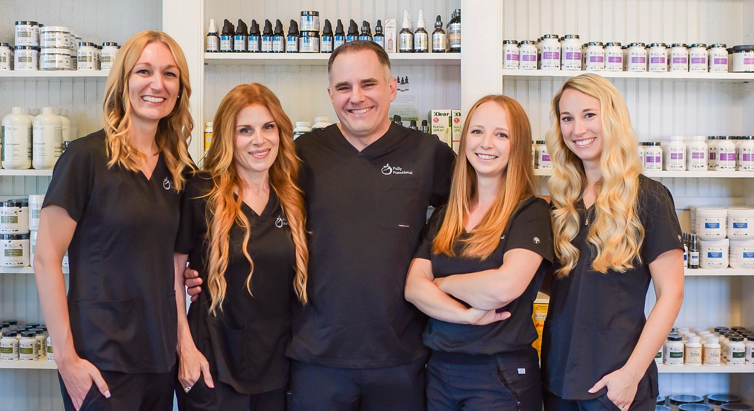 Team of wellness professionals in black uniforms.