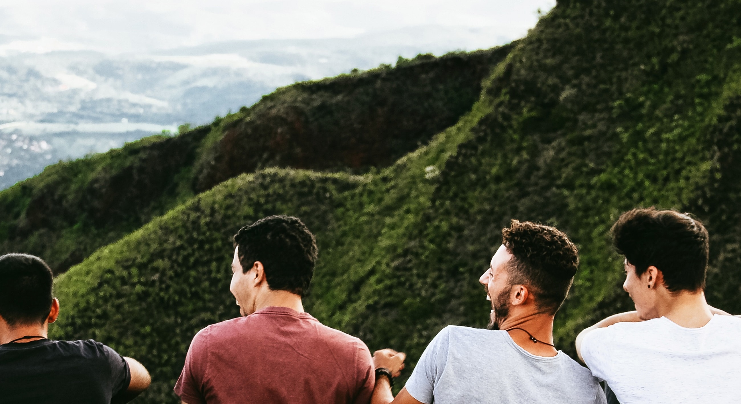 Friends enjoying nature on a hillside.