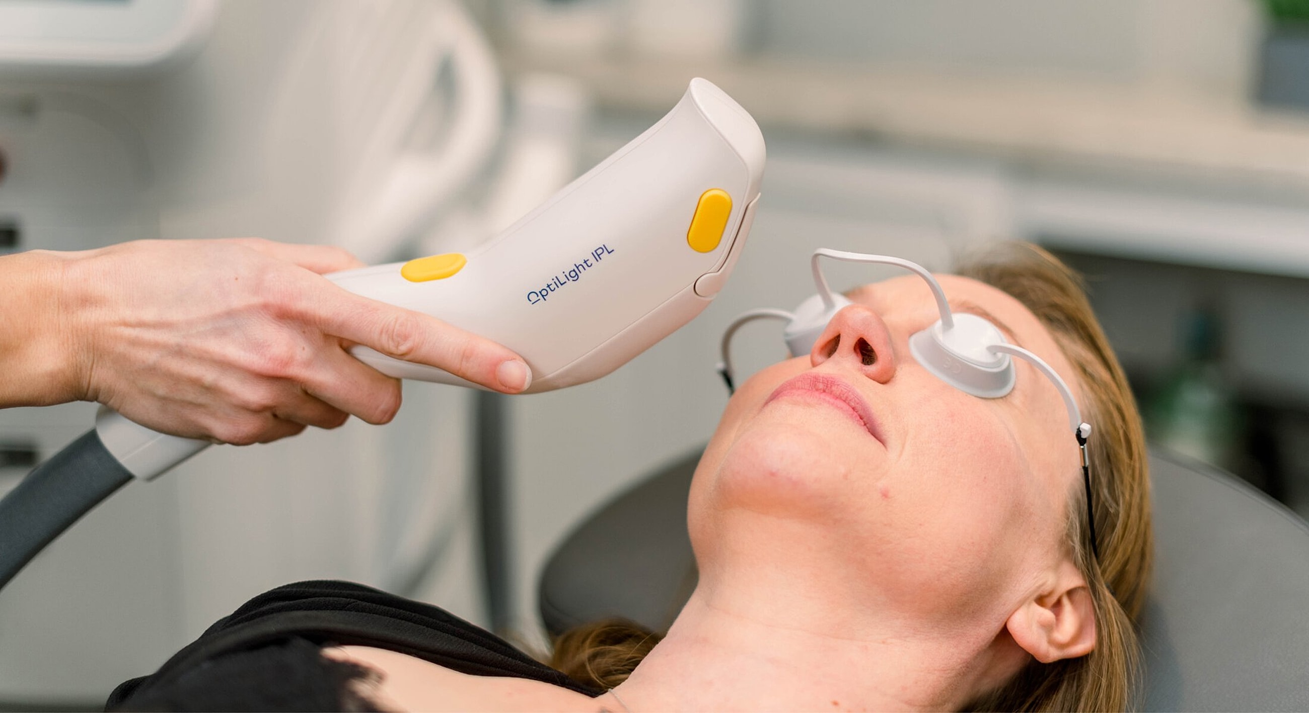 Facial treatment using IPL device on patient.