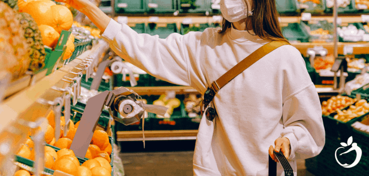 women in a mask shopping at a grocery store