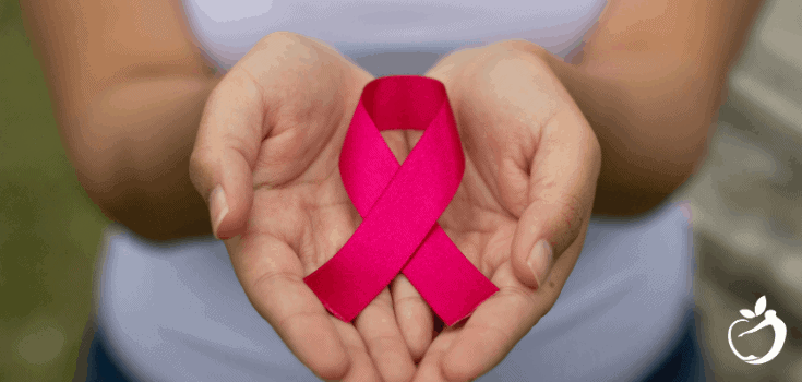 Carmel functional medicine patient model holding a pink ribbon