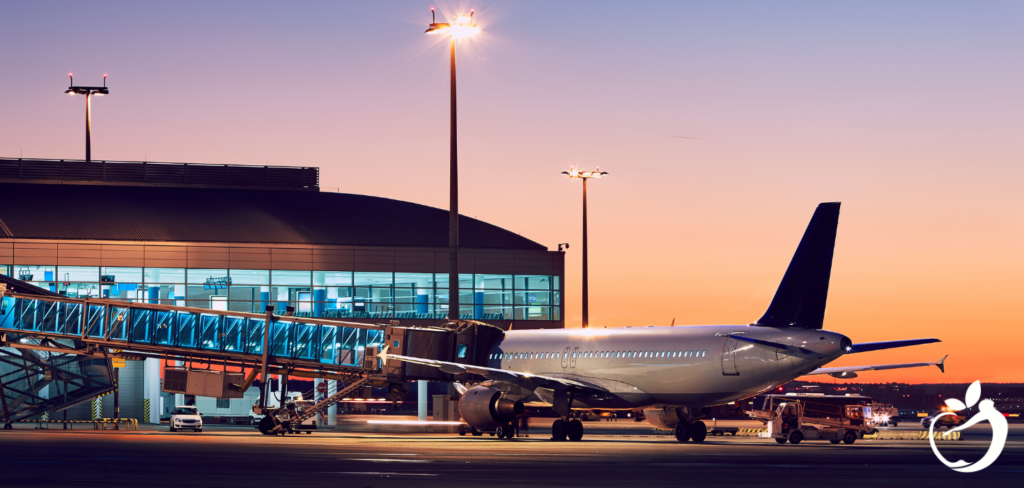 Blog Post Header Image - How to Avoid Jet Lag: Dr. Ellen’s Pro Tips. Image of plane at airport terminal gate.