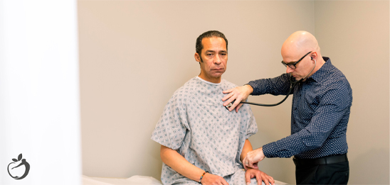 Image of a doctor listening to a patient's chest for long COVID