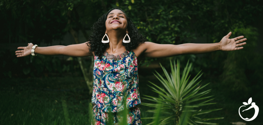 woman standing outside with her arm outstretched