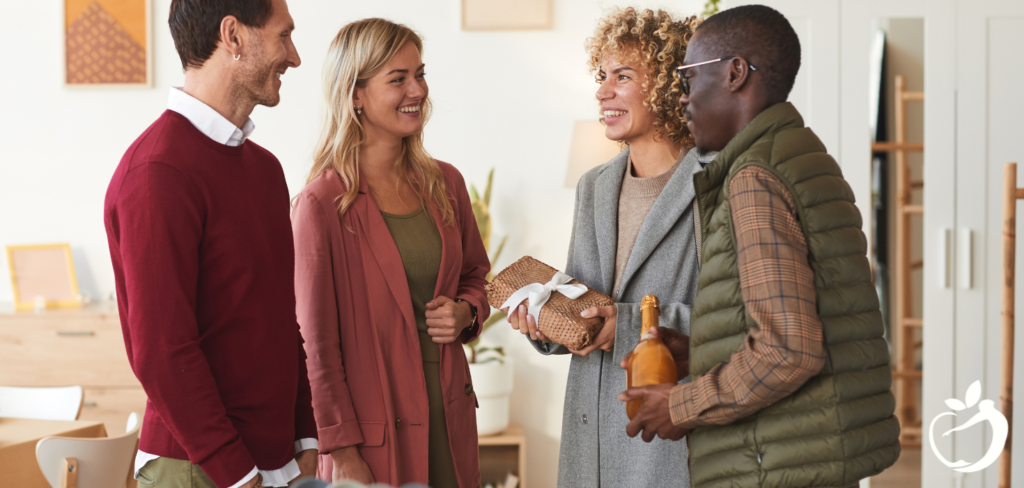 four people standing and talking with each other