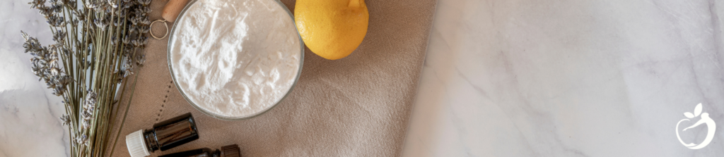 lemon, baking soda, and essential oils on a counter