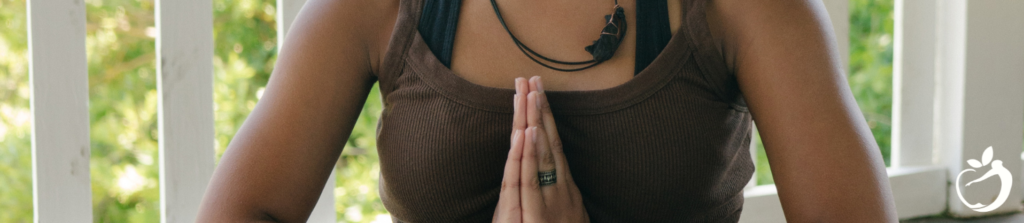 woman in a green tank top meditating