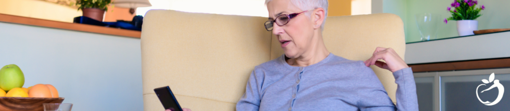 iv therapy patient model looking at her mobile phone while sitting in a large chair