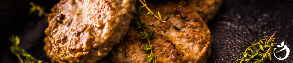 breakfast sausages in a pan with thyme