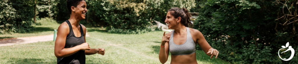 two women jogging outdoors and laughing