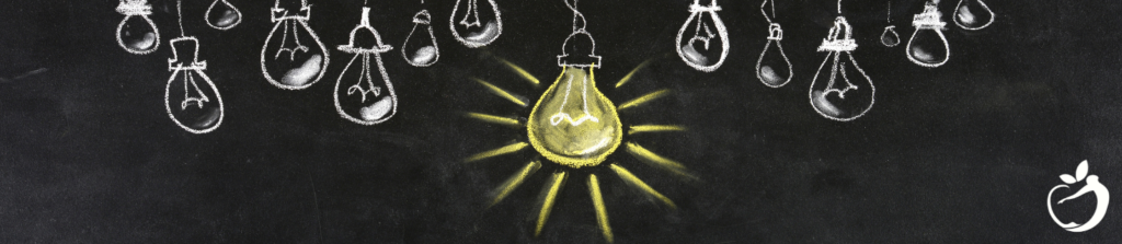 Image showing lightbulbs drawn onto a chalkboard to demonstrate a lightbulb going on when we shift our mindset.