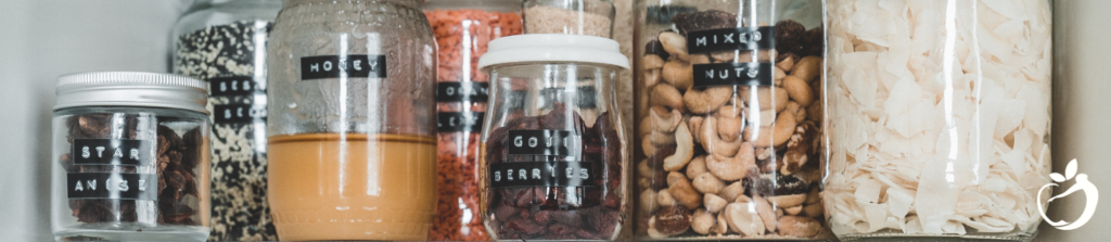 an organized, uncluttered pantry full of glass jars of foodstuffs