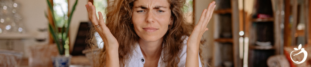 woman frowning and throwing her hands up