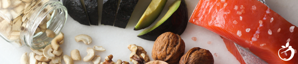 salmon avocado and nuts on a white cutting board