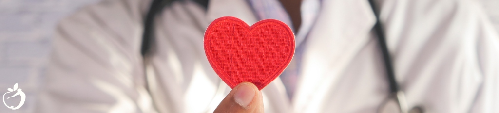 doctor holding a cut out paper heart