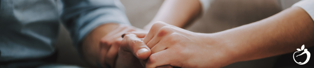 Image of two people holding hands, demonstrating accountability and the benefits of health coaching.