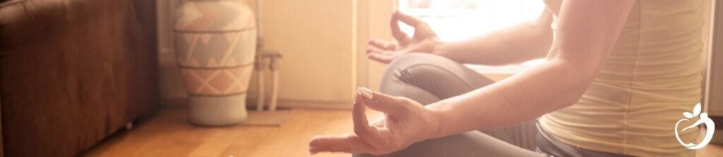 woman sitting down meditating