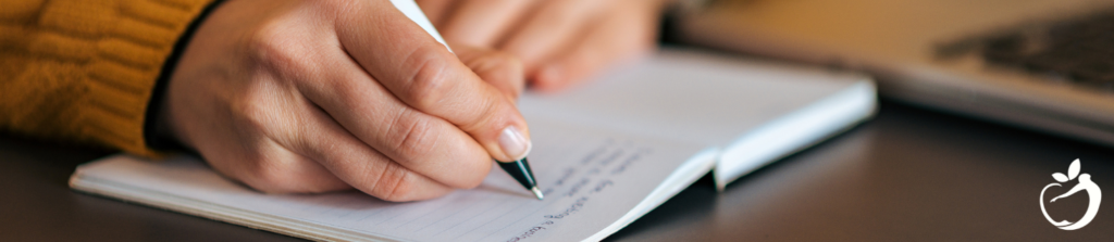 person writing in a notebook