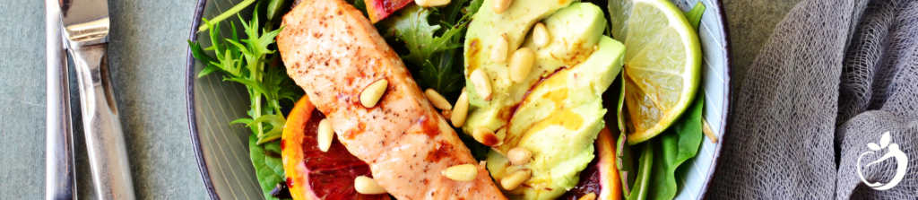 salmon, avocado, and salad on a plate