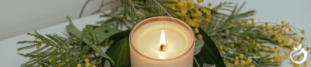 a lit candle surrounded by garland