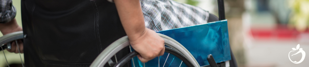 Person in a wheelchair, dealing with multiple sclerosis, may benefit from low dose naltrexone.