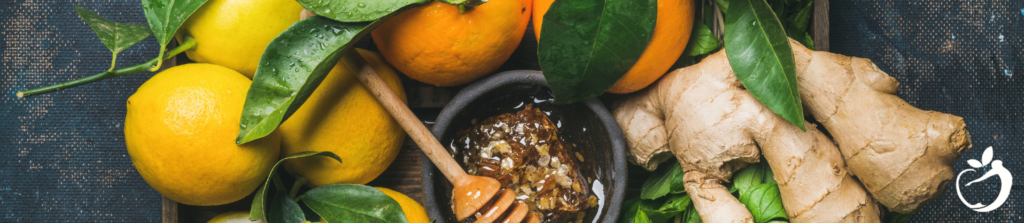 lemons, ginger, oranges, and honey on a table