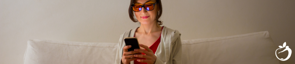 Image of a woman wearing blue light blocking glasses to help regulate circadian rhythm. Tips for improving sleep.
