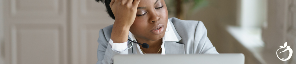 woman with her head in her hand and her eyes closed