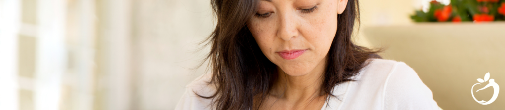 Image of a woman looking down, considering what is normal as it relates to pelvic floor therapy.