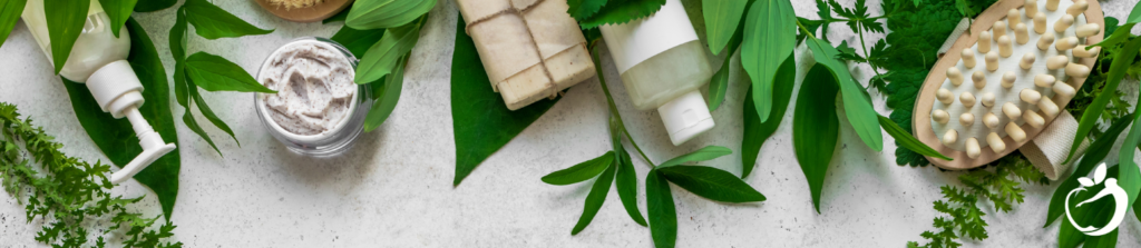 skincare products and leaves on a white tabletop