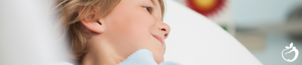 child smiling on a hospital bed