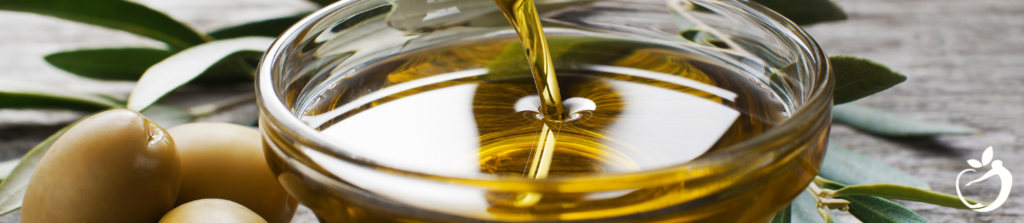 olive oil being poured into a glass bowl