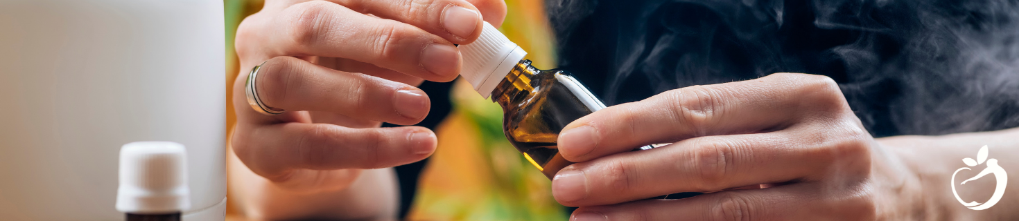 Image of a person holding essential oil being used for emotional healing.
