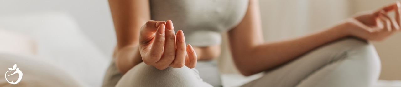 women sitting cross legged on the floor meditating