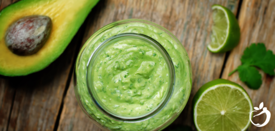 Recipe Post Header Image - Avocado Cilantro Lime Dressing. Image of green dressing in a glass jar.