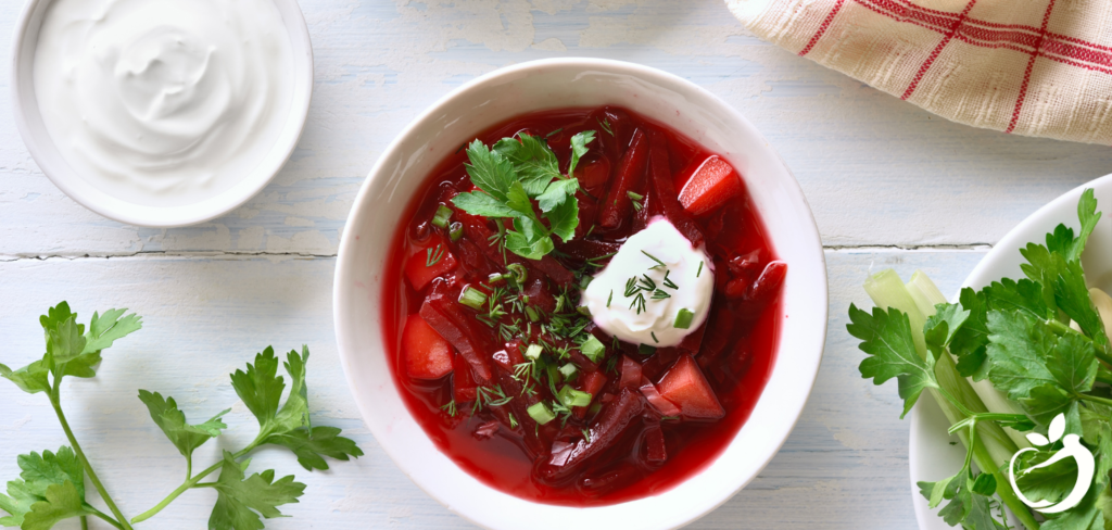 Healthy Borscht in a bowl topped with coconut yogurt