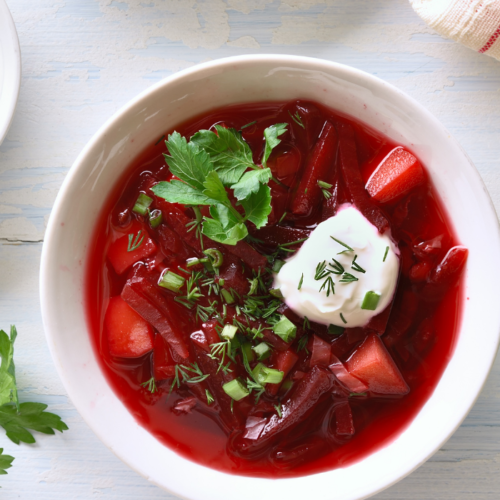 Image of Easy Healthy Borscht in a bowl topped with coconut yogurt.