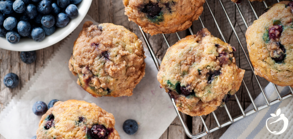 Recipe Post Header Image - Grain-Free Blueberry Muffins. Image of muffins on cooling rack.