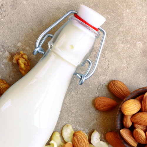 Nuts and nut milk in glass bottle