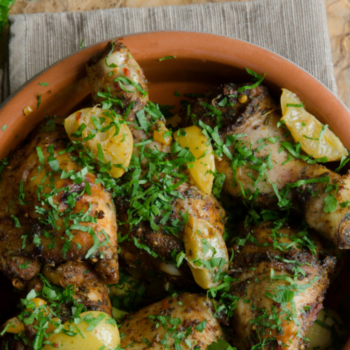 Recipe Post Header Image - Moroccan Chicken with Chickpeas. Image of chicken on serving platter.
