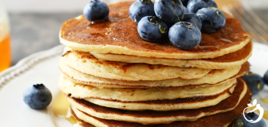 Recipe Post Header Image - Paleo Pancakes With Plantains. Image of pancakes on a plate with blueberries on top.
