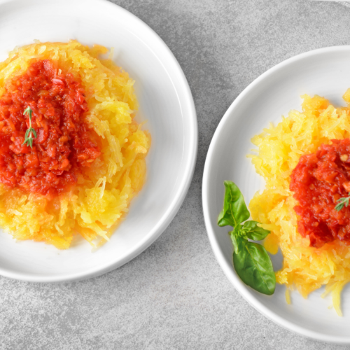 closeup of Spaghetti Squash Noodles with Vegetable Marinara and Basil on a plate